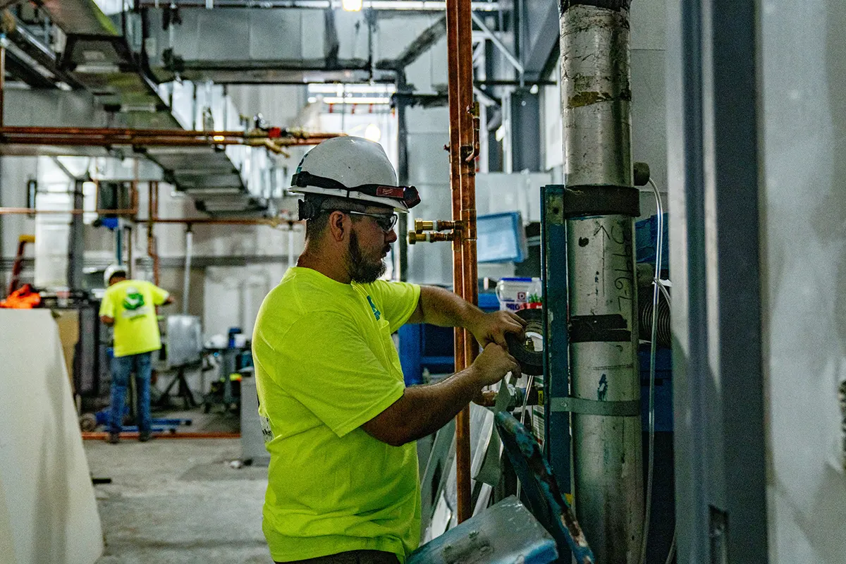 CCS crew member at work on a piping run